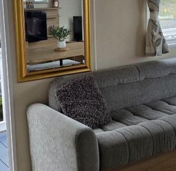 A living room with a sofa and a television at Port Haverigg Cabin Sleeps 4, Steel Green near Haverigg