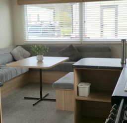 A living room with a sofa and table at Port Haverigg Cabin Sleeps 4 Steel Green near Haverigg