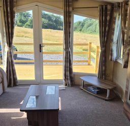 A living room with a sofa and coffee table at Cabin - Sleeps 6 - Outdoor Pool and Parking in Cenarth