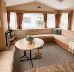 A living room with a sofa and table at Seaside Tranquility Retreat in Clacton