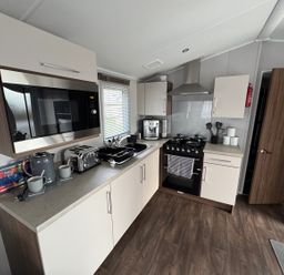 A kitchen with appliances and storage at Wl34 Caravan Haggerston Castle Private Decking Haggerston