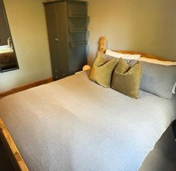 A bedroom with a bed and wardrobe at Pet Friendly 2-Bed Lodge, Sleeps 5, Pool & Parking, Caernarfon