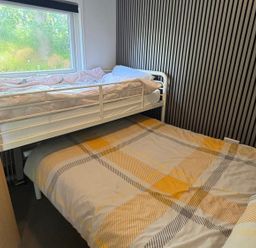 A bedroom with a bunk bed and a double bed at Pet Friendly 2-Bed Lodge, Sleeps 5, Pool & Parking, Caernarfon