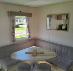 A dining area with a corner seating and table at Ye Old'e Man - Sleeps 6 & Pet Friendly near Flookburgh