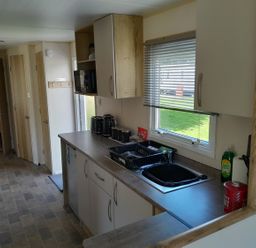 A kitchen with cabinets and a sink at Ye Old'e Man - Sleeps 6 & Pet Friendly Near Flookburgh