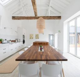 A kitchen with a dining table and chairs at Simple Coastal Luxury near Southwold