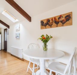 A kitchen with a table and chairs at The Shippon, Breathtaking Views, Private Hot Tub Winkleigh