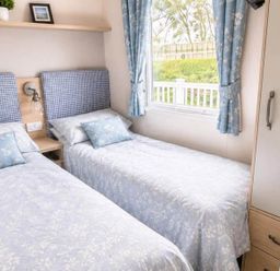 A bedroom with two beds and a window at Tattershall Lakes - Hot Tub - Sleeps 6 - Pets in Tattershall