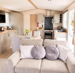 A kitchen/living area with a sofa and dining table at Tattershall Lakes - Hot Tub - Sleeps 6 - Pets Tattershall