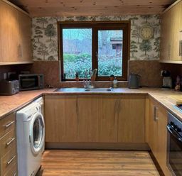 A kitchen with appliances and a window at Cabin Sleeps 4 with Hot Tub and Parking near Wilberfoss