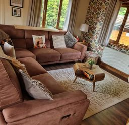 A living room with a sofa and coffee table at Cabin Sleeps 4 with Hot Tub and Parking Near Wilberfoss