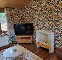 A living room with a television and seating area at Cabin Sleeps 4 with Hot Tub and Parking near Wilberfoss