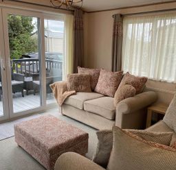 A living room with a sofa and ottoman at a property