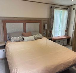 A bedroom with a bed and bedside table at 