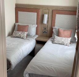A bedroom with twin beds and a bedside table