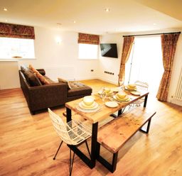 A living room with a sofa and dining table at Newly Refurbished Cottage, sleeping 4 and Central, Berwick-Upon-Tweed