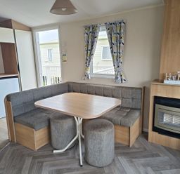 A dining area with a table and seating at Golden Sands 3-Bed Caravan, Parking and Pet Friendly, Towyn