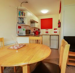 A kitchen with dining table and chairs at Villa 12 near Camelford