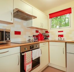 A kitchen with appliances and a window at Villa 12 near Camelford