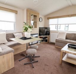 A living room with a sofa and a television at B54