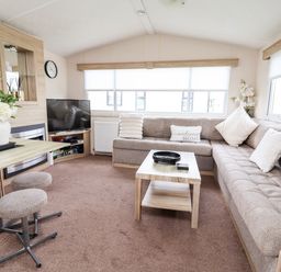 A living room with a sofa and TV at B54