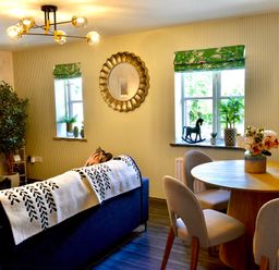 A living room with a table and chairs at Muddy Boots – La Petite Mews Kirby Stephen