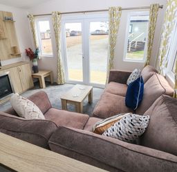 A living room with a sofa and coffee table at Seascape in Haverfordwest