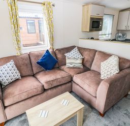 A living room with a sofa and coffee table at Seascape in Haverfordwest