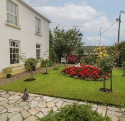 A garden with flowers and a path at Bruckless Rest Fine Country Dining B&amp;B in Bruckless