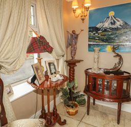 An entryway with a lamp and table displaying pictures at Bruckless Rest Fine Country Dining B&amp;B Bruckless