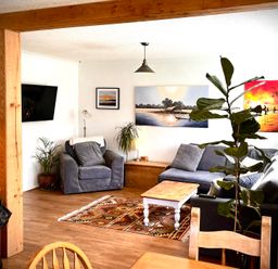 A living room with a sofa and table at Ty Marlyn in St Davids