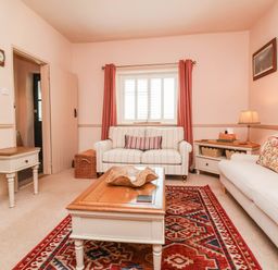 A living room with a sofa and coffee table at Myrtle Cottage in Lynmouth