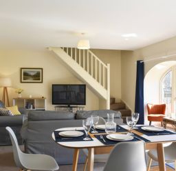 A living room with a dining table and sofa at The Hayloft in Hexham