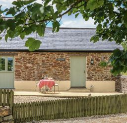 An outdoor area with a table and chairs at Beech Cottage in Truro