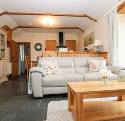 A living room with a sofa and coffee table at Beech Cottage in Truro