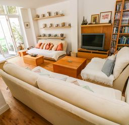 A living room with a sofa and coffee table at Basement Apartment in Tenby