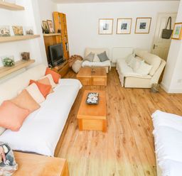 A living room with sofas and a coffee table at Basement Apartment in Tenby