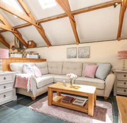 A living room with a sofa and coffee table at Oak Cottage in Truro