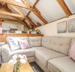A living room with a sofa and a coffee table at Oak Cottage in Truro