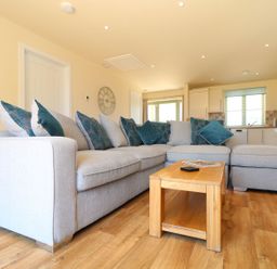 A living room with a sofa and coffee table at Elm Cottage in Truro