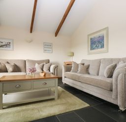 A living room with sofas and a coffee table at Ash Cottage in Truro