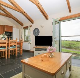 A kitchen with a table and chairs at Ash Cottage in Truro