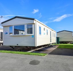 A mobile home with stairs and windows at Beach Fields 45 Kinmel Bay
