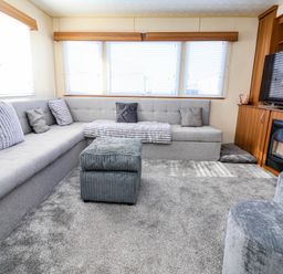A living room with a sofa and television at Beach Fields 45 in Kinmel Bay