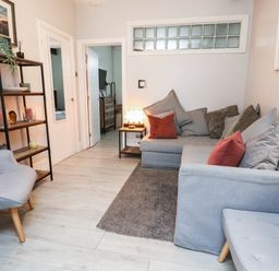 A living room with sofa and bookshelf at Flat 1, 2 Wooperton Street Weymouth