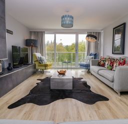 A living room with a coffee table and television at 10 Rayrigg Rise Bowness-On-Windermere
