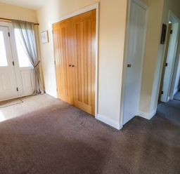A hallway with a front door and closet at The Bungalow in Penrith