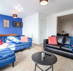 A living room with a sofa and coffee table at Flat 4 Greenfields Barmouth