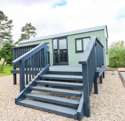 A cabin with steps and a porch at Calendonia Hut West Mains near Haggerston