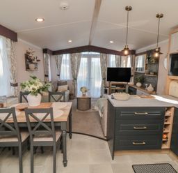 A kitchen with a dining table and sofa at 19 Finch